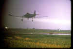 Crop duster spraying chemicals on a field
